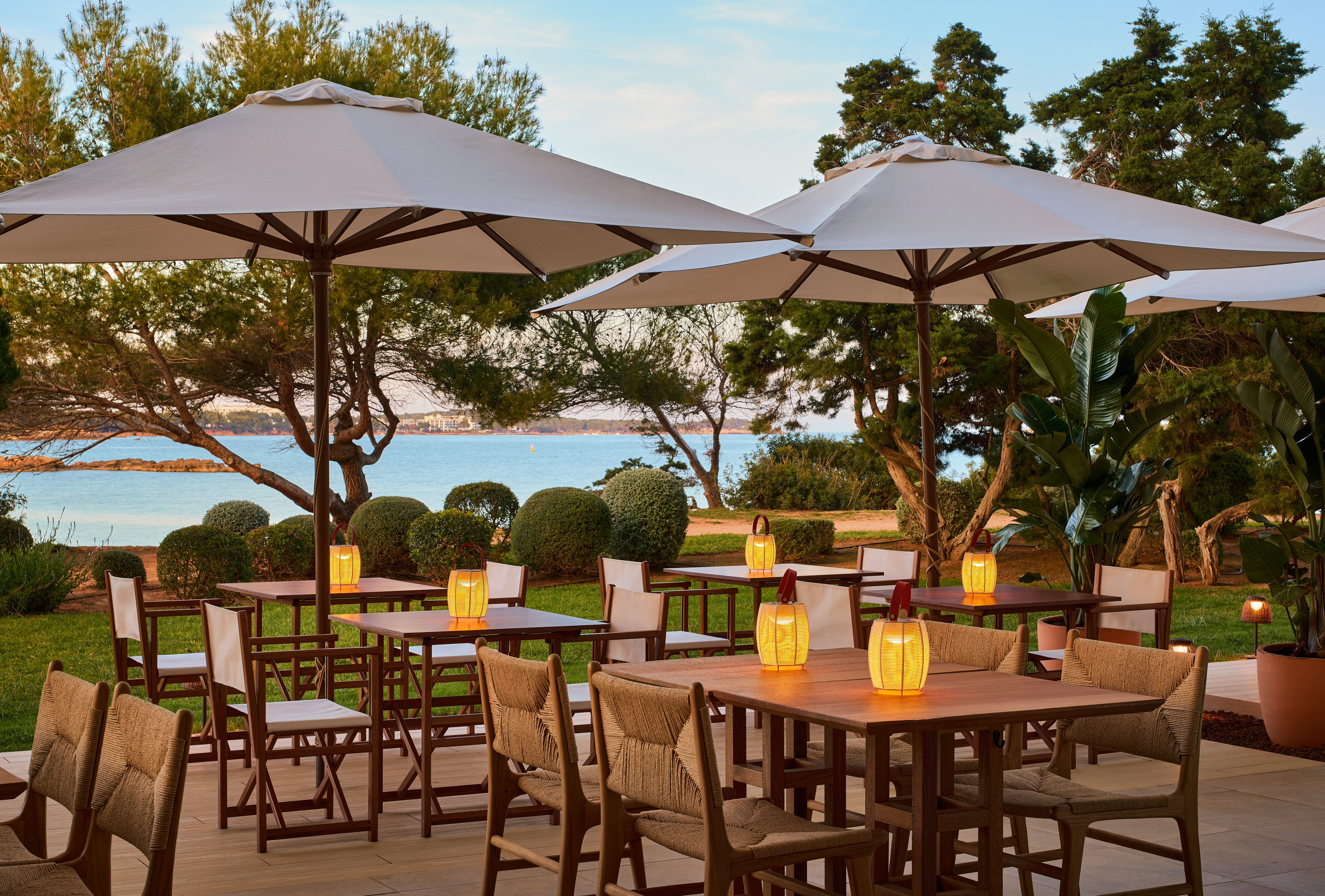 a table and chairs under umbrellas