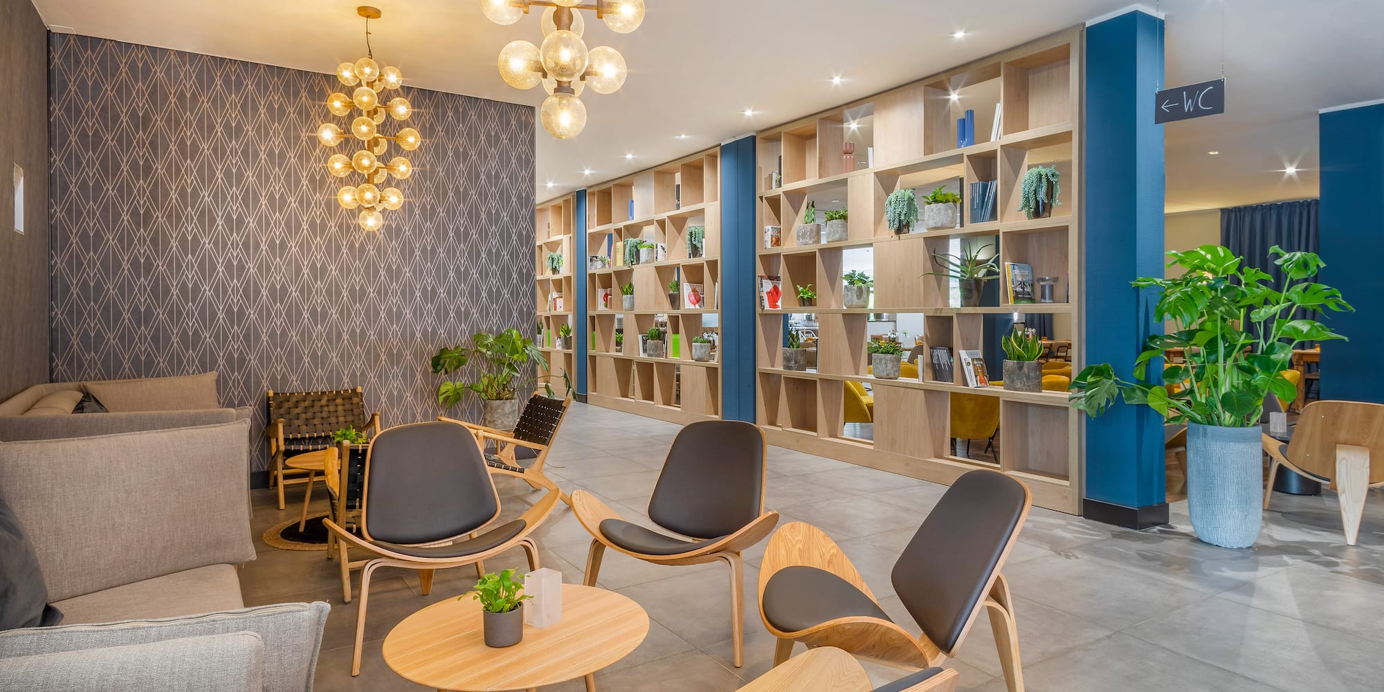 a room with a bookcase and chairs