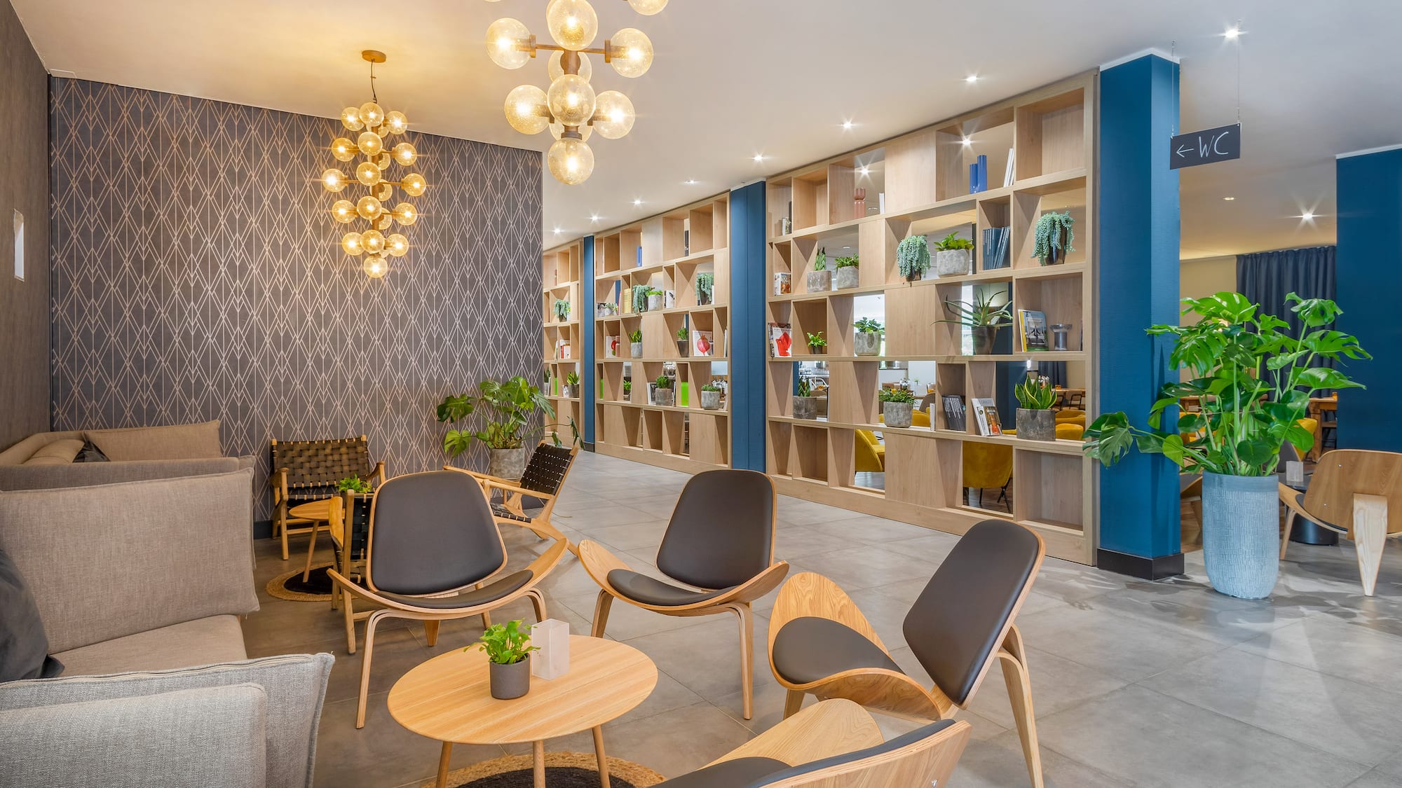 a room with a bookcase and chairs