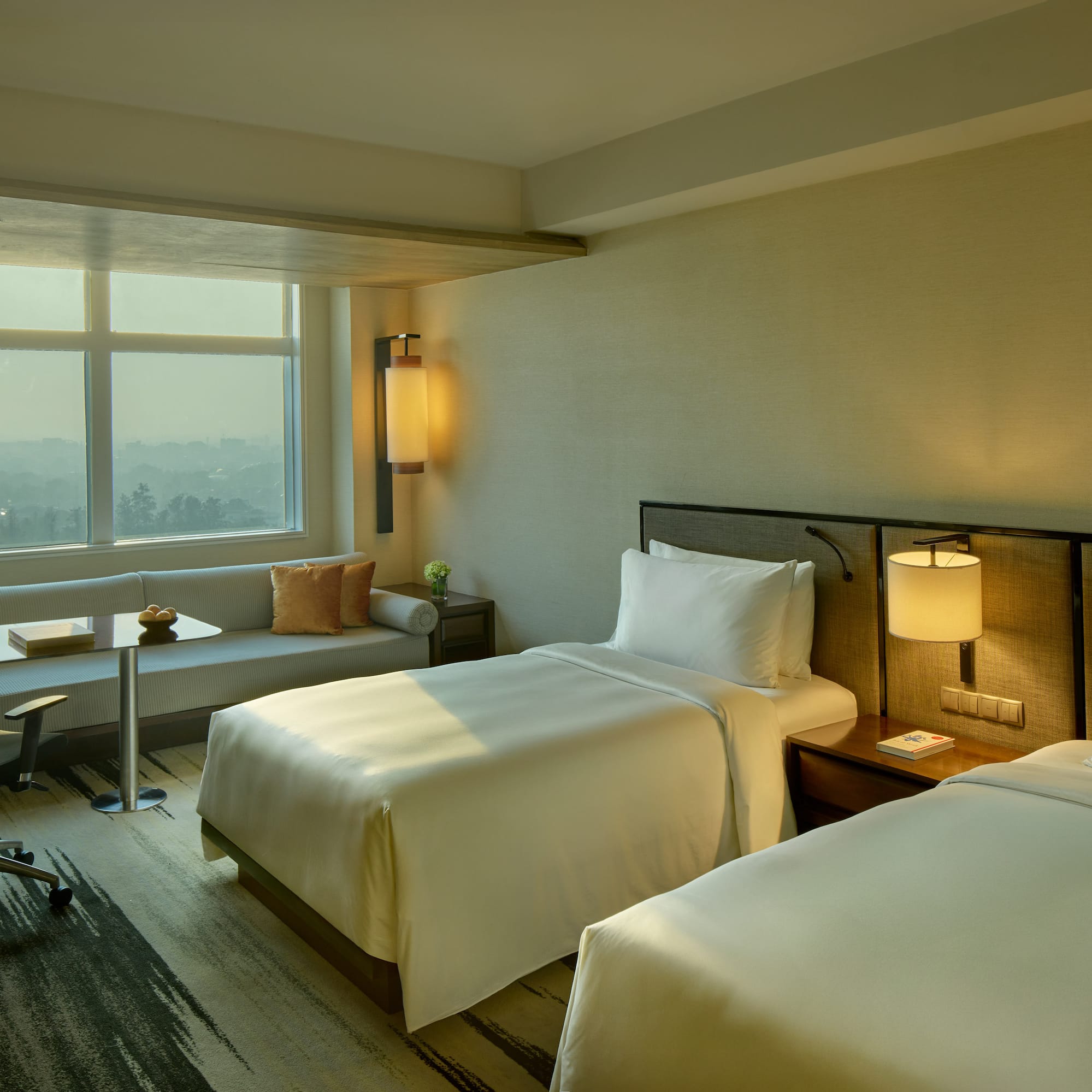 a room with two beds and a table