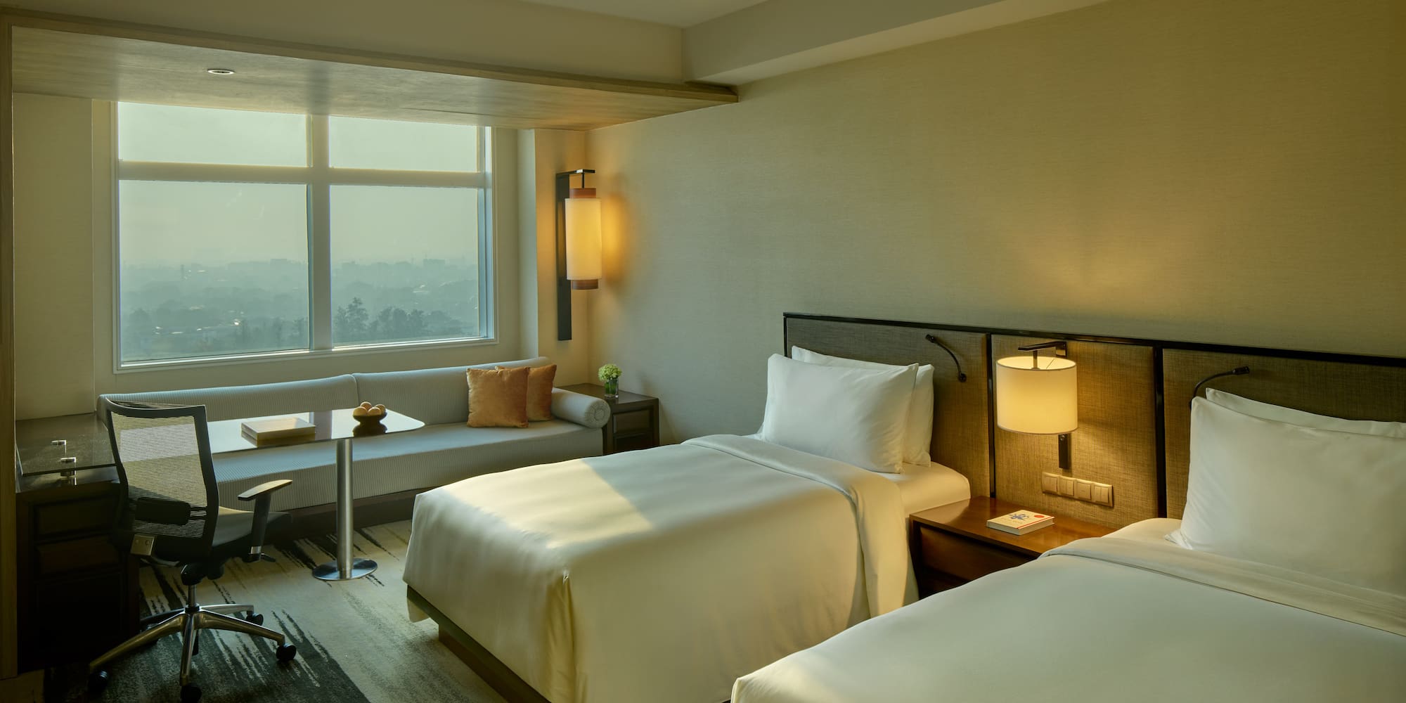 a room with two beds and a table