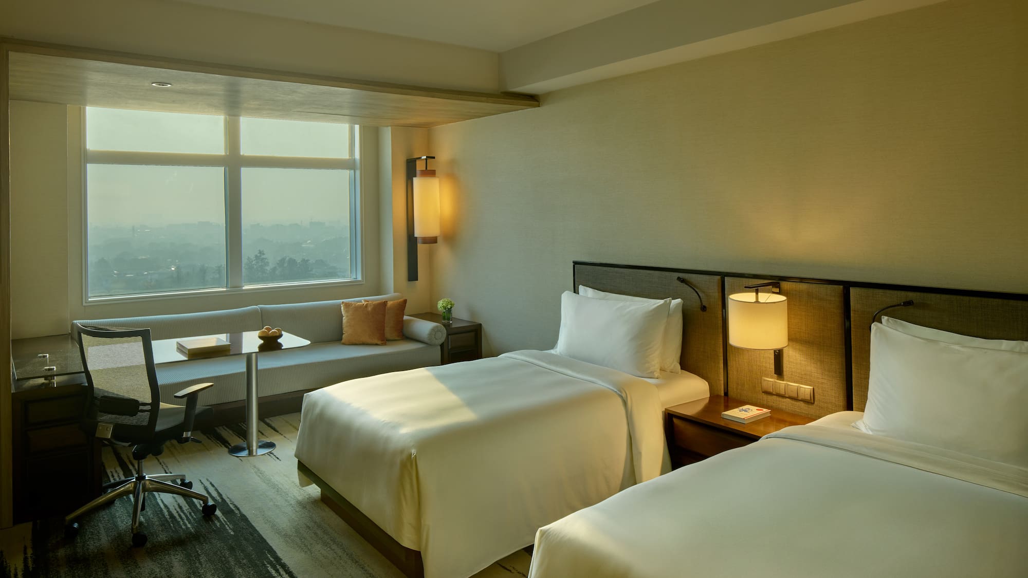 a room with two beds and a table