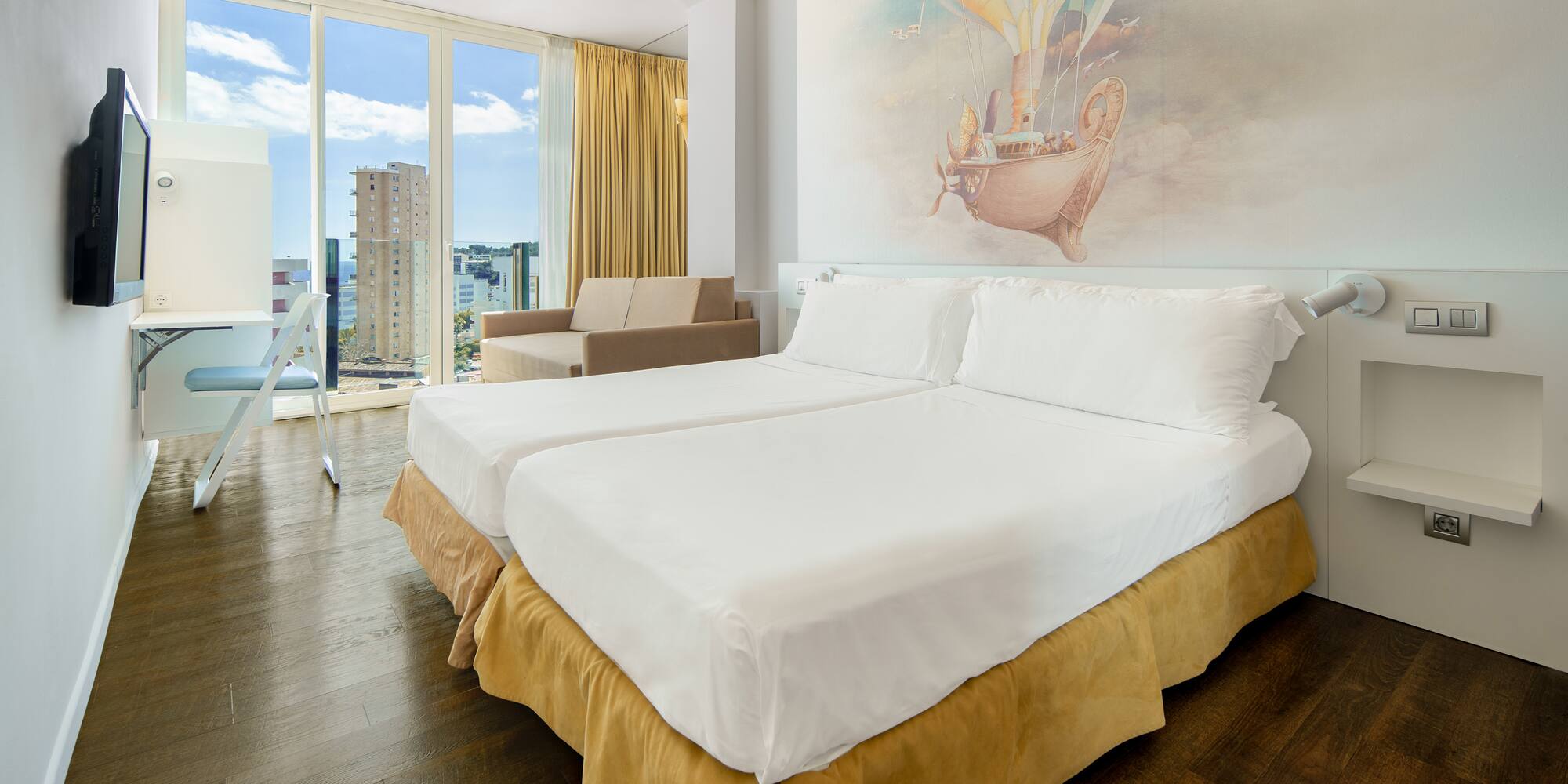 a room with two beds and a picture on the wall