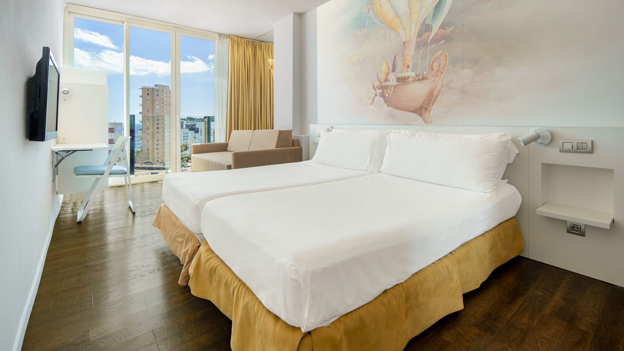 a room with two beds and a picture on the wall