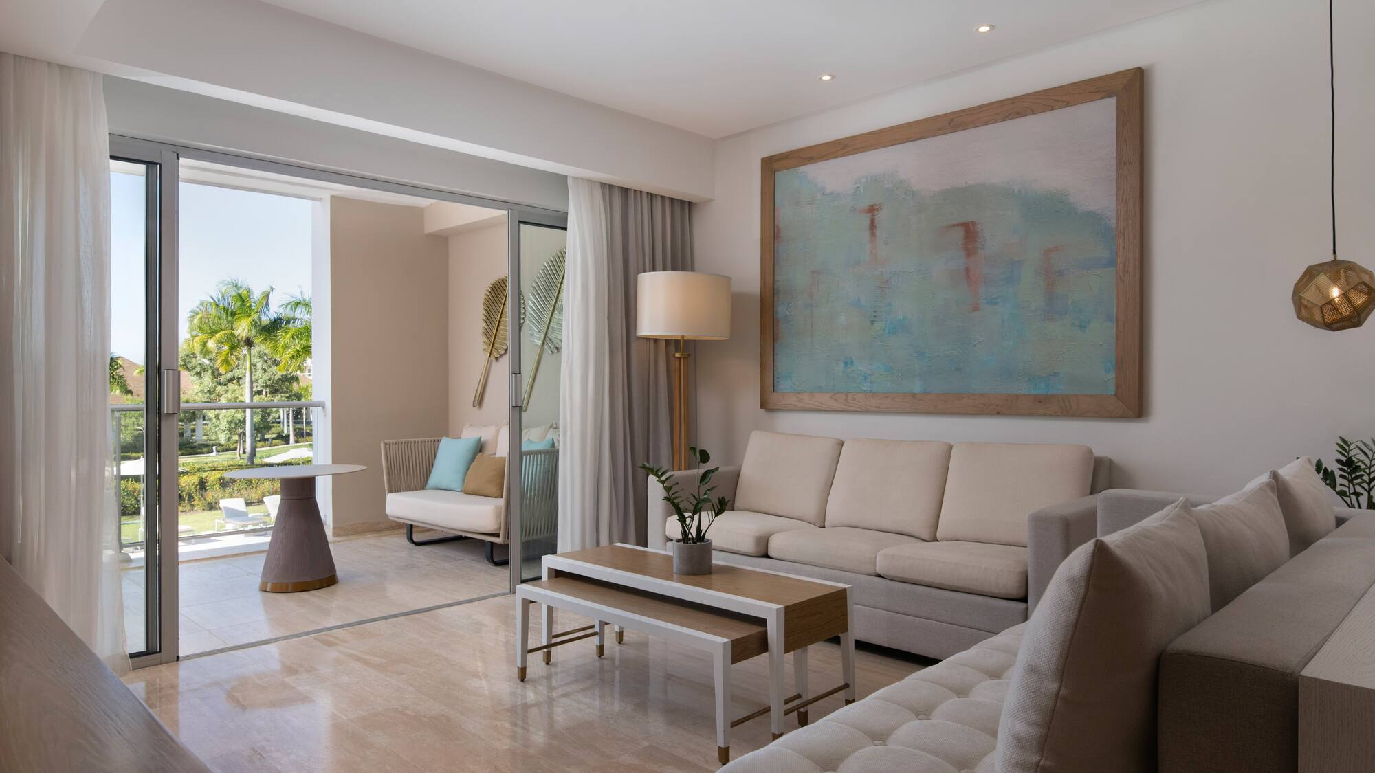 a living room with a large painting on the wall