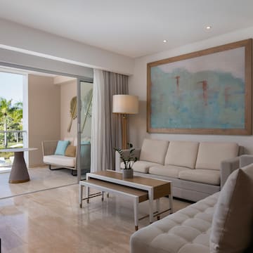 a living room with a large painting on the wall