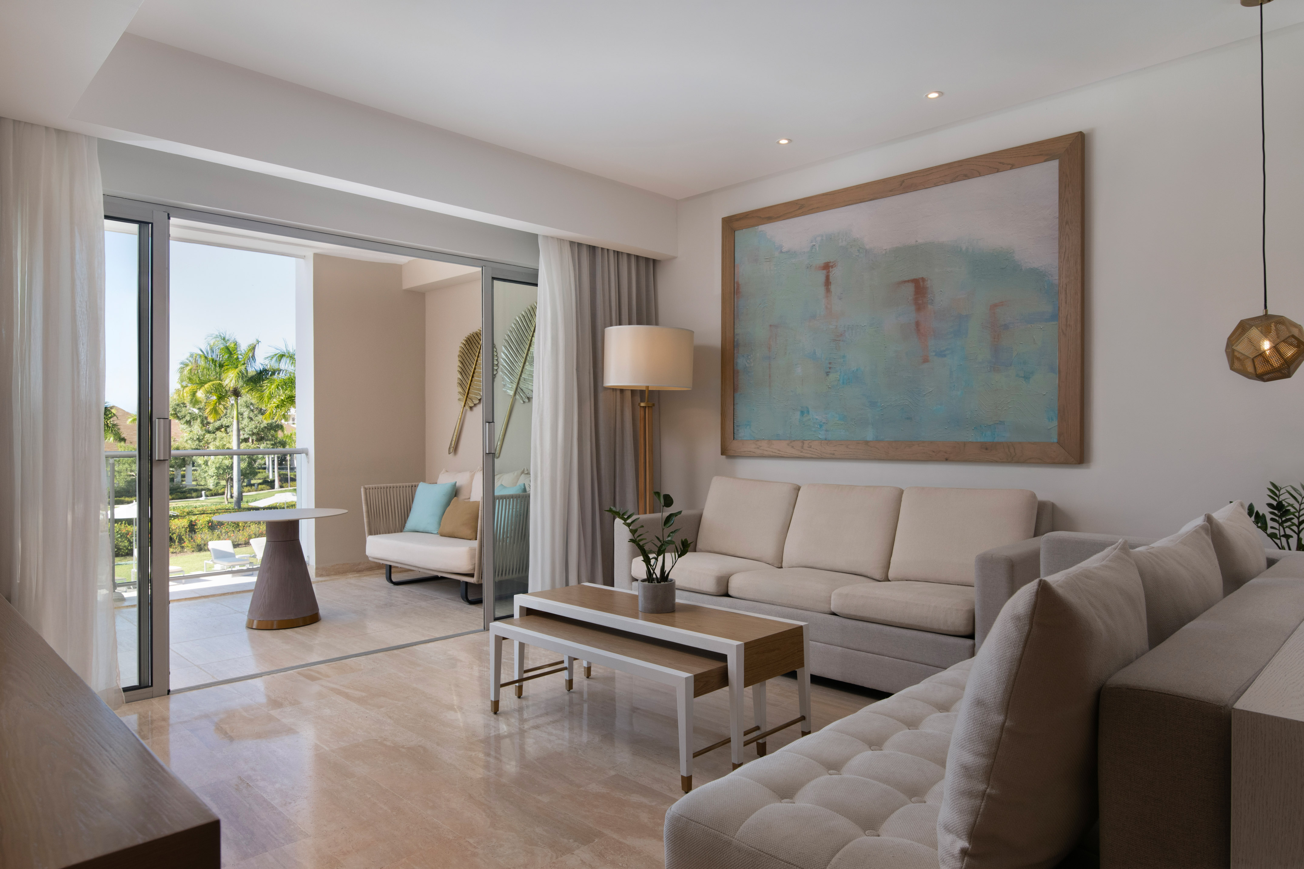 a living room with a large painting on the wall