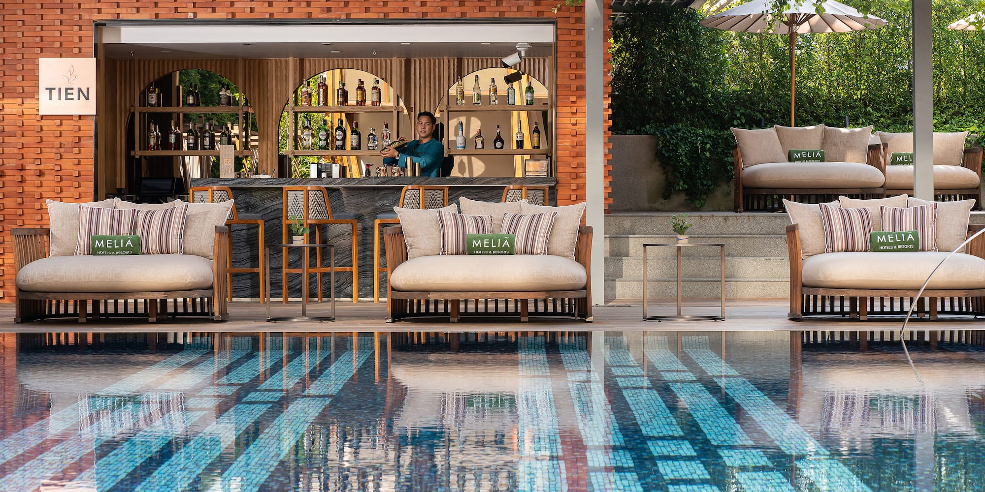 a pool with chairs and tables and a bar