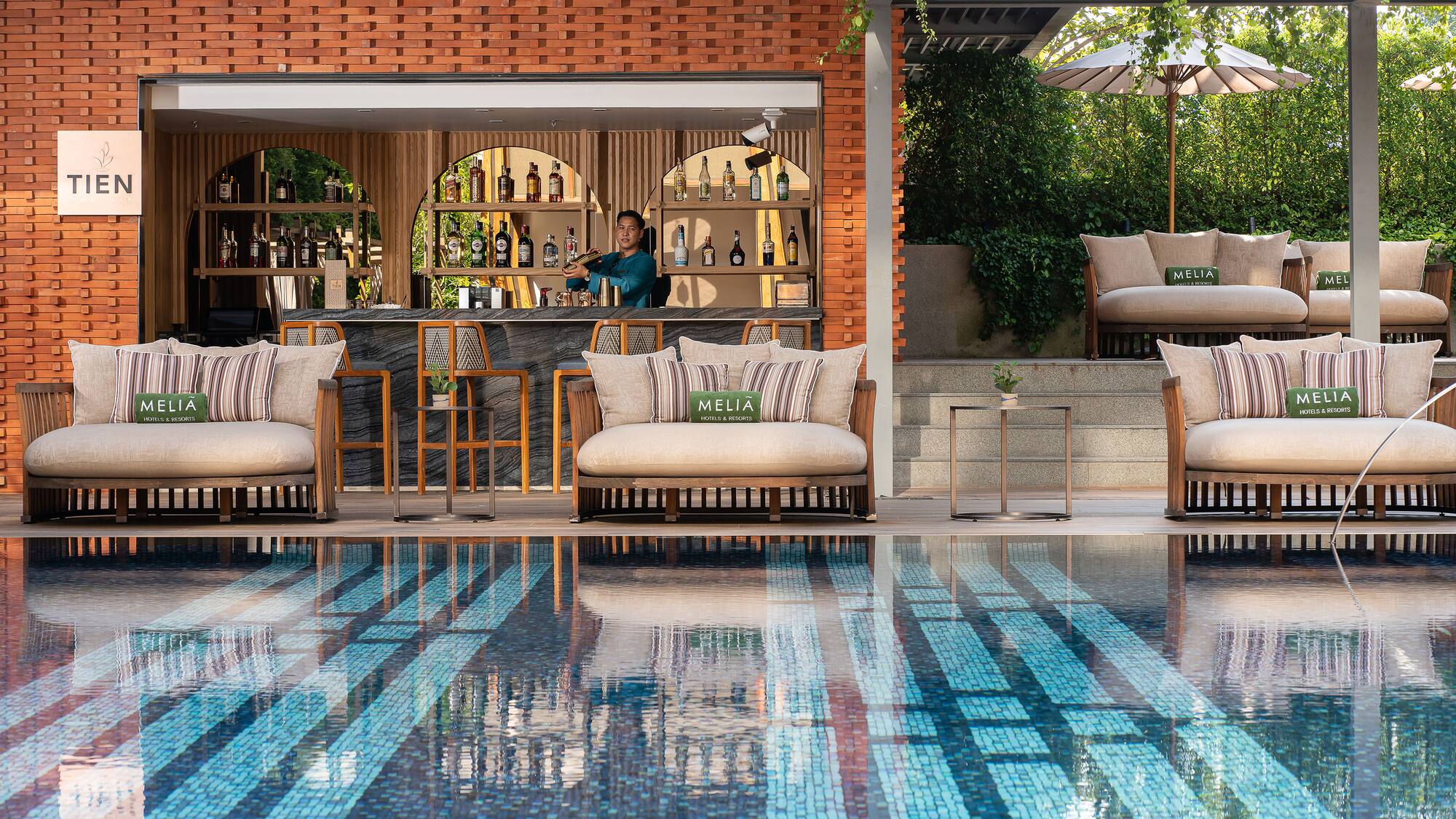 a pool with chairs and tables and a bar