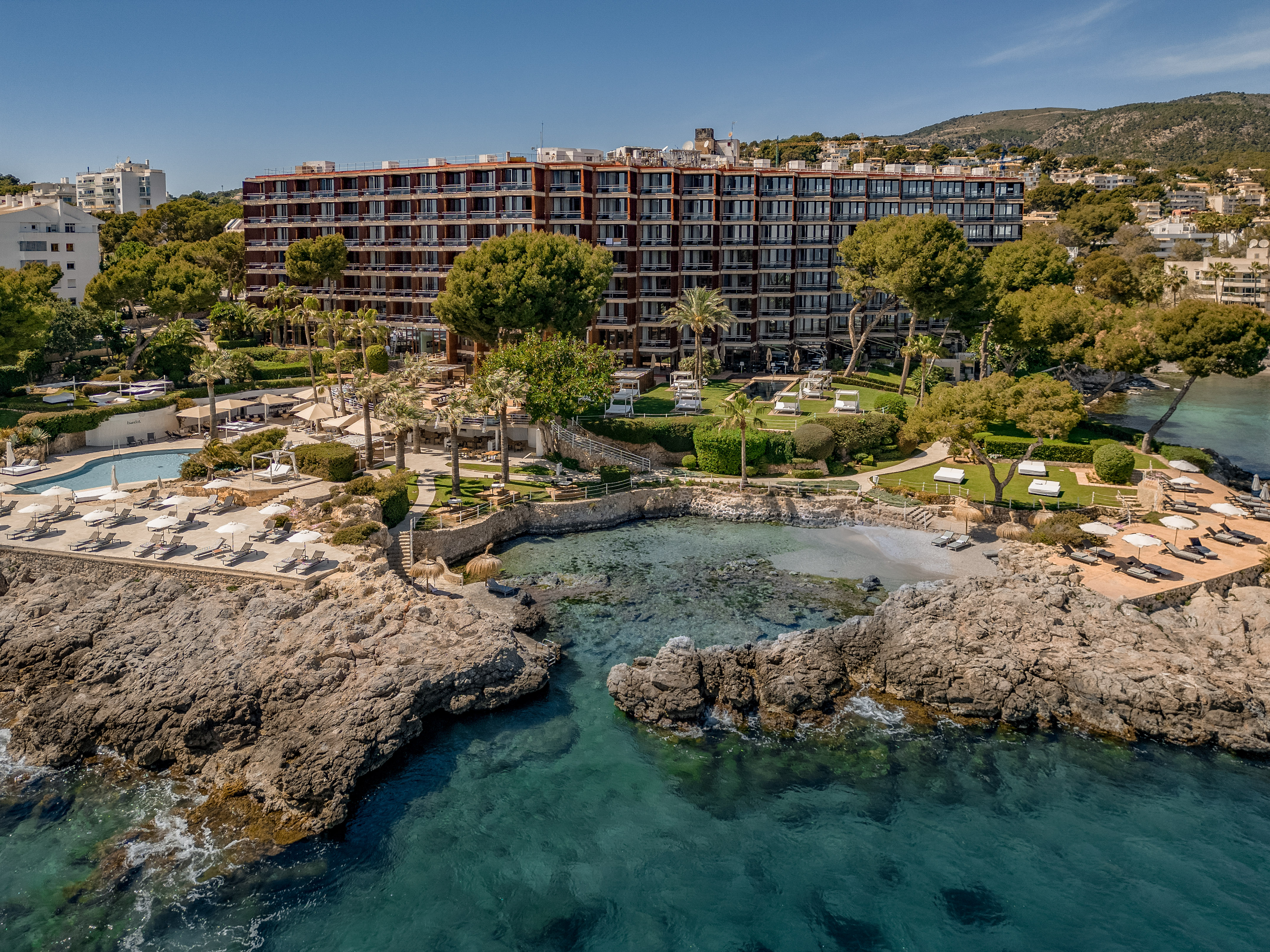 Mallorca beachfront resort with private cove, pool, and lush gardens.