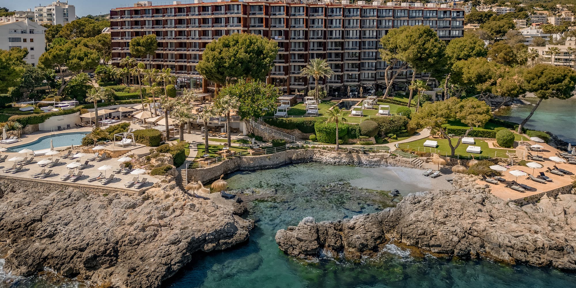 Mallorca beachfront resort with private cove, pool, and lush gardens.