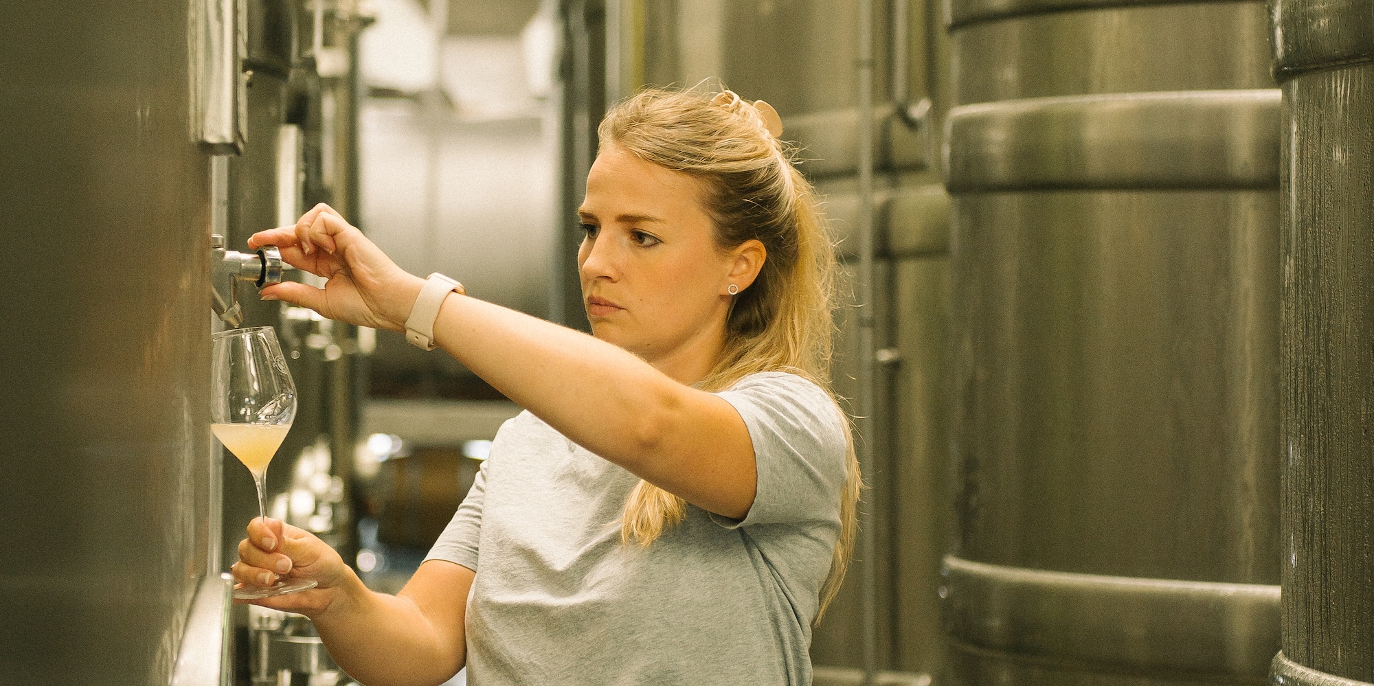 a woman holding a glass of liquid