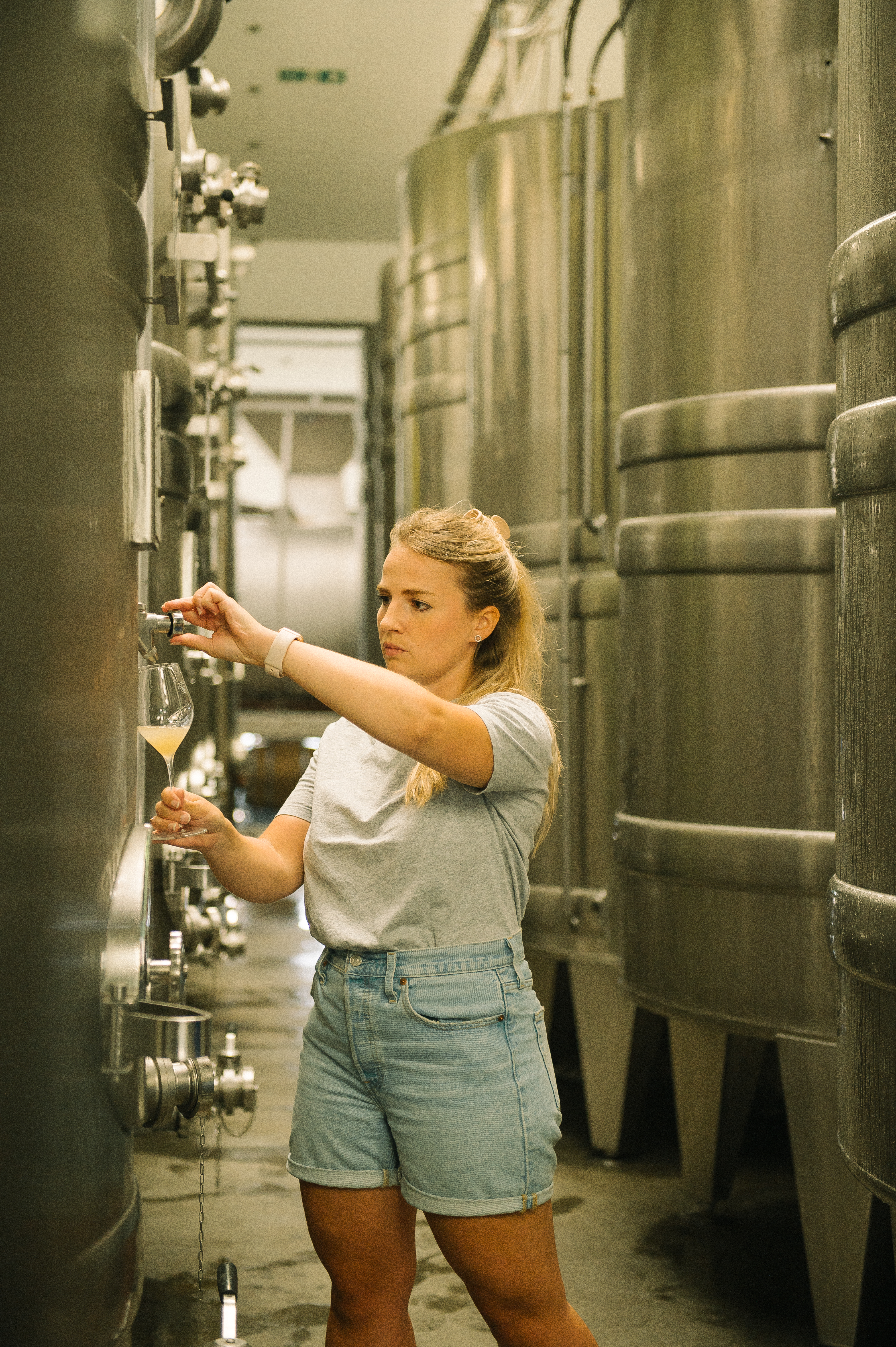 a woman holding a glass of liquid