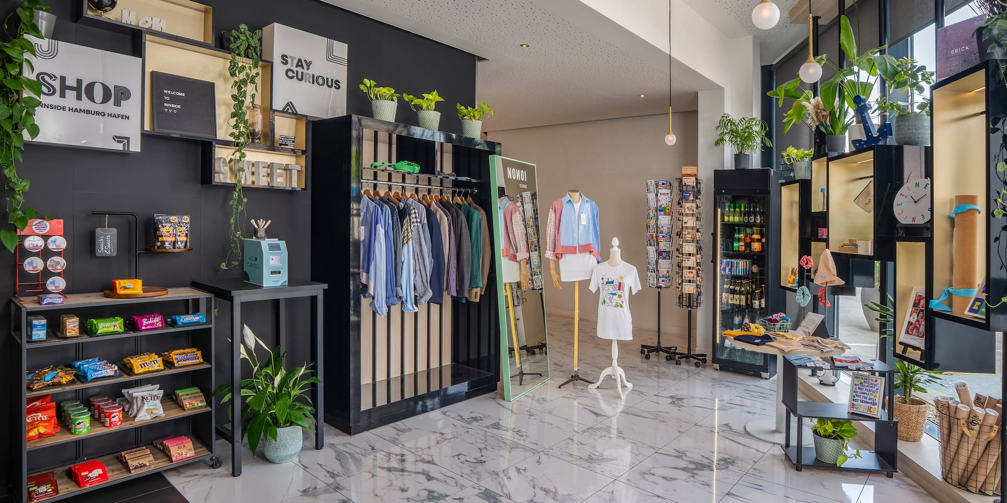 a store with a variety of clothes on swingers