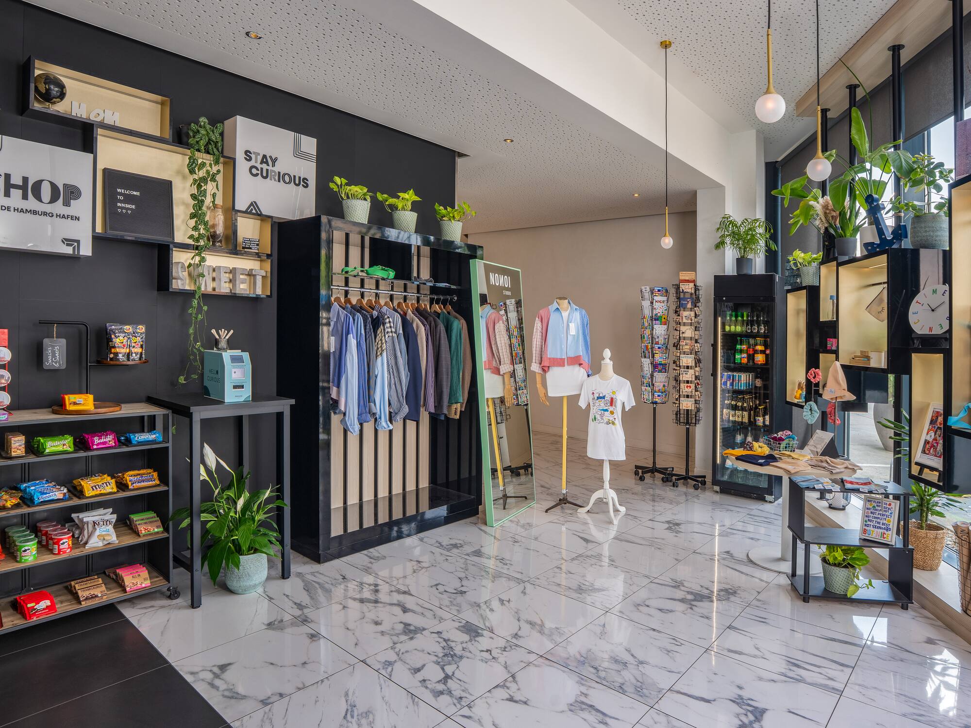 a store with a variety of clothes on swingers