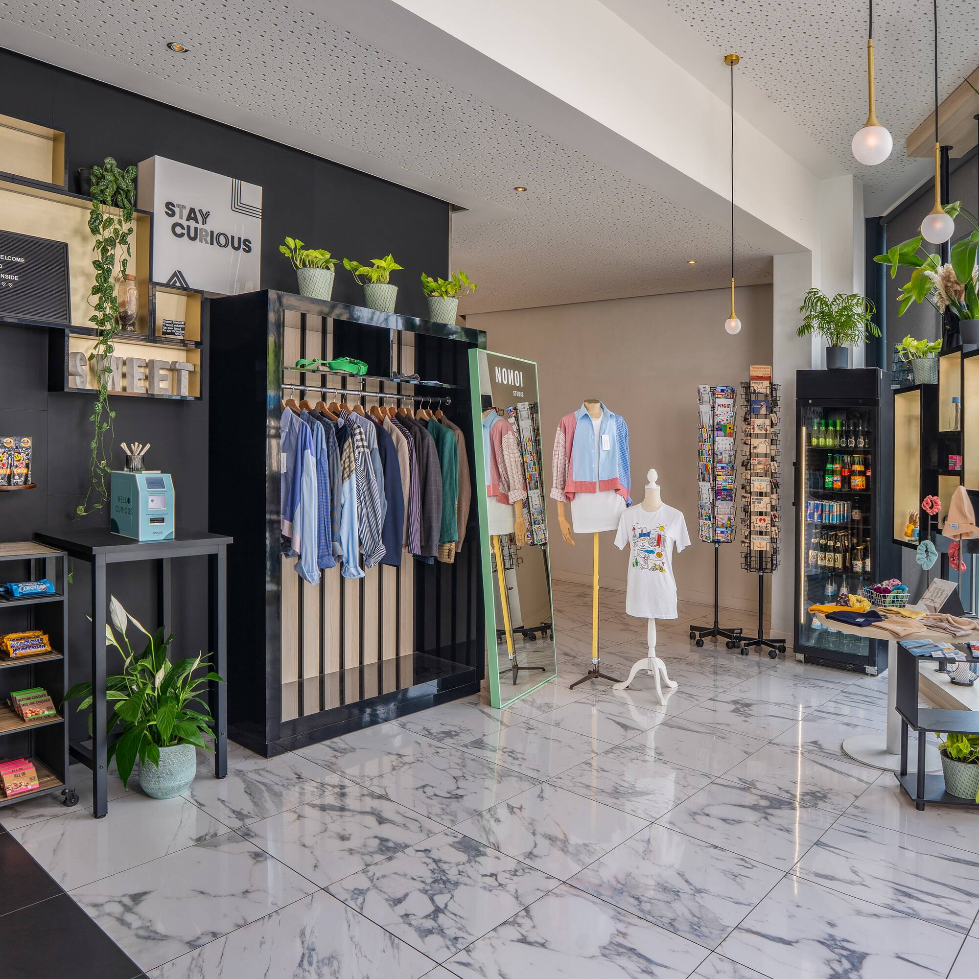 a store with a variety of clothes on swingers