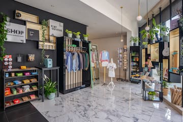 a store with a variety of clothes on swingers