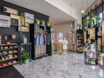 a store with a variety of clothes on swingers