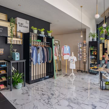 a store with a variety of clothes on swingers