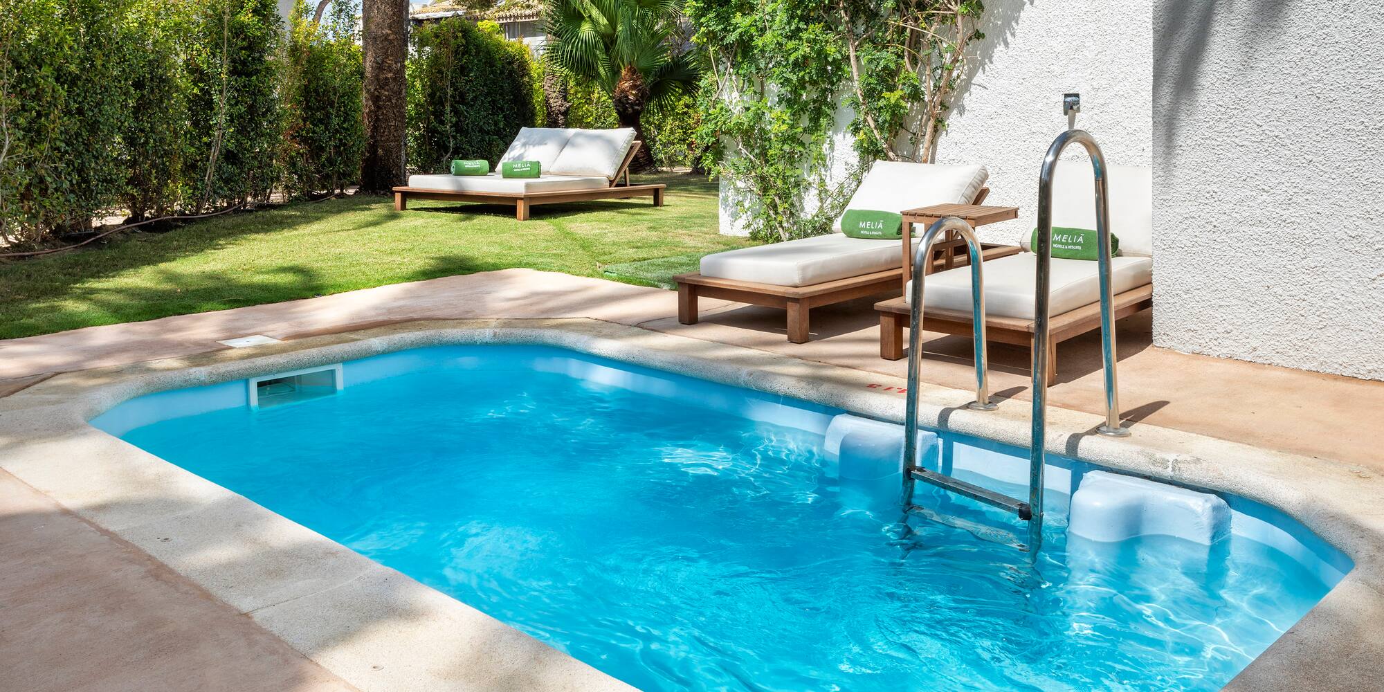 a pool with lounge chairs and a deck