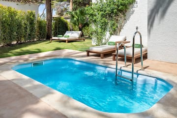 a pool with lounge chairs and a deck