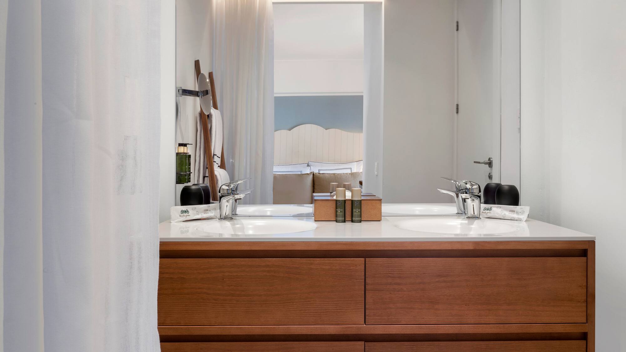 a bathroom with a double sink and mirror