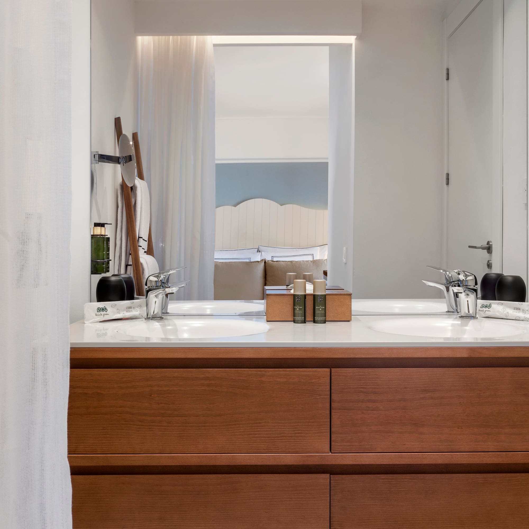 a bathroom with a double sink and mirror