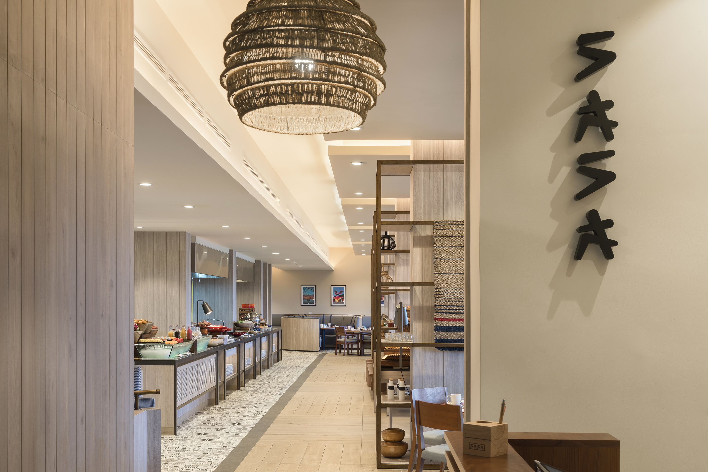 Modern restaurant buffet area with woven pendant light and contemporary decor.