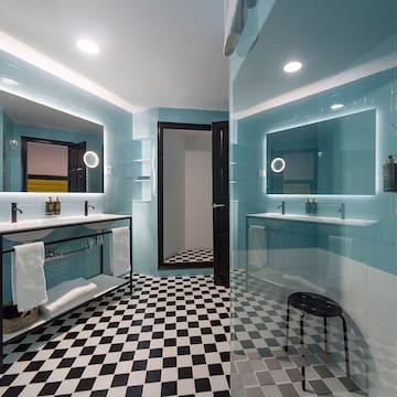 a bathroom with a mirror and a shower