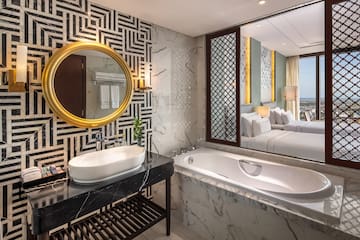 a bathroom with a mirror and a tub