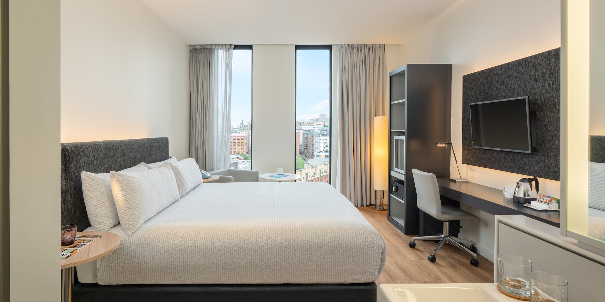 a bedroom with a large bed and a desk