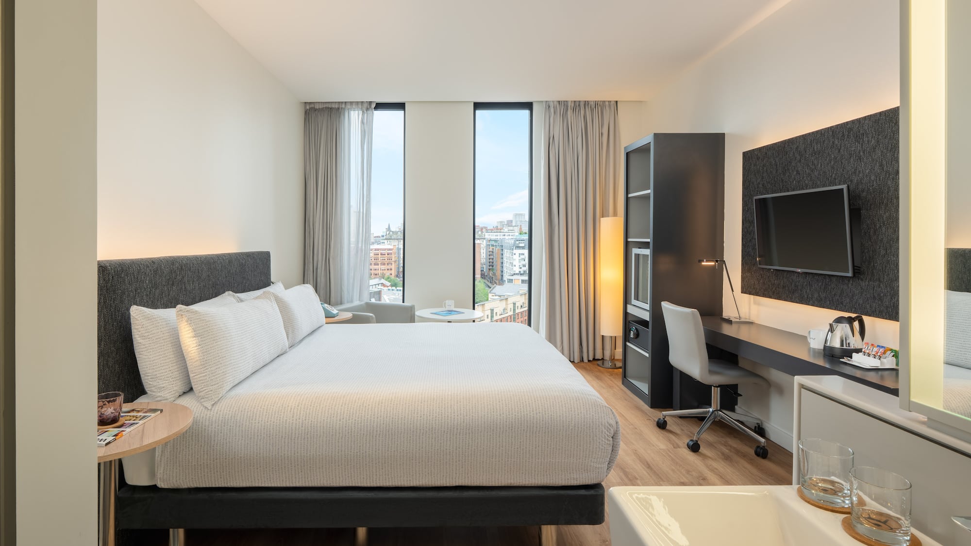 a bedroom with a large bed and a desk