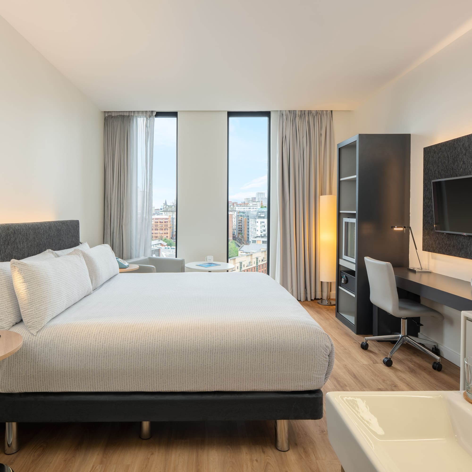 a bedroom with a large bed and a desk