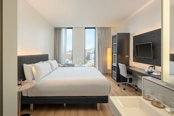 a bedroom with a large bed and a desk