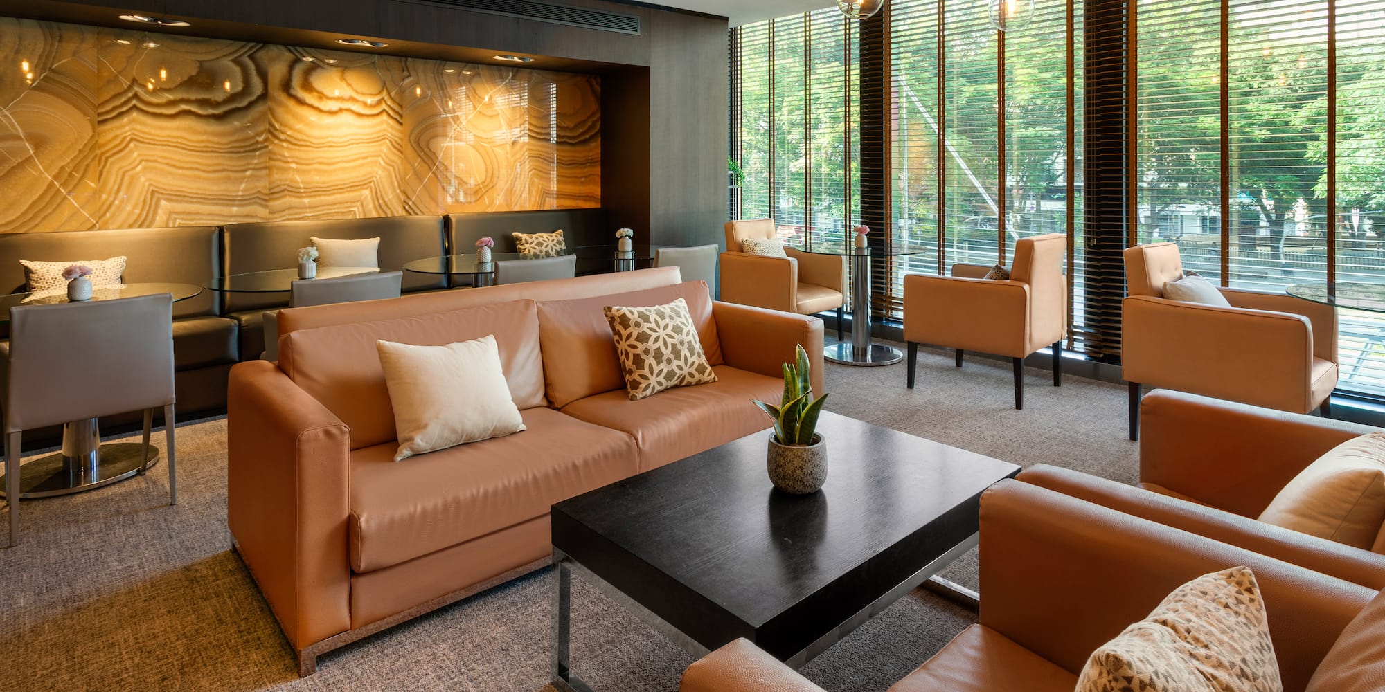 a room with brown couches and a black coffee table