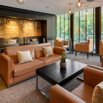 a room with brown couches and a black coffee table