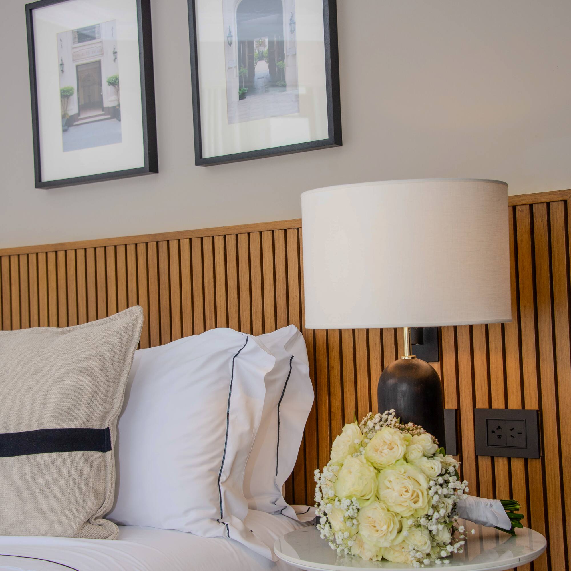 a bed with a lamp and flowers