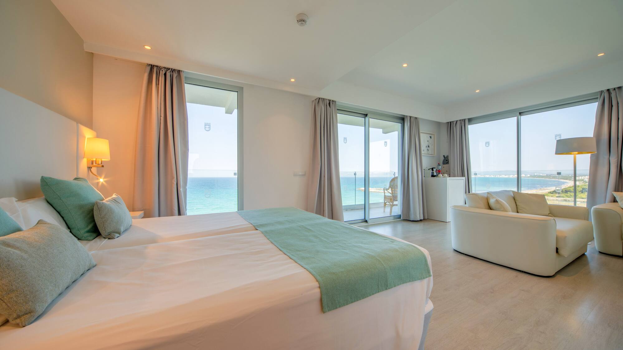 a bedroom with a large bed and a couch