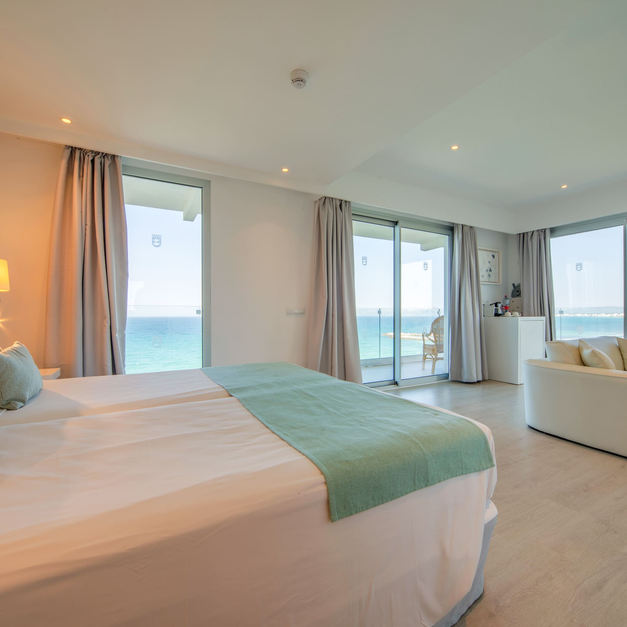 a bedroom with a large bed and a couch