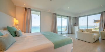 a bedroom with a large bed and a couch