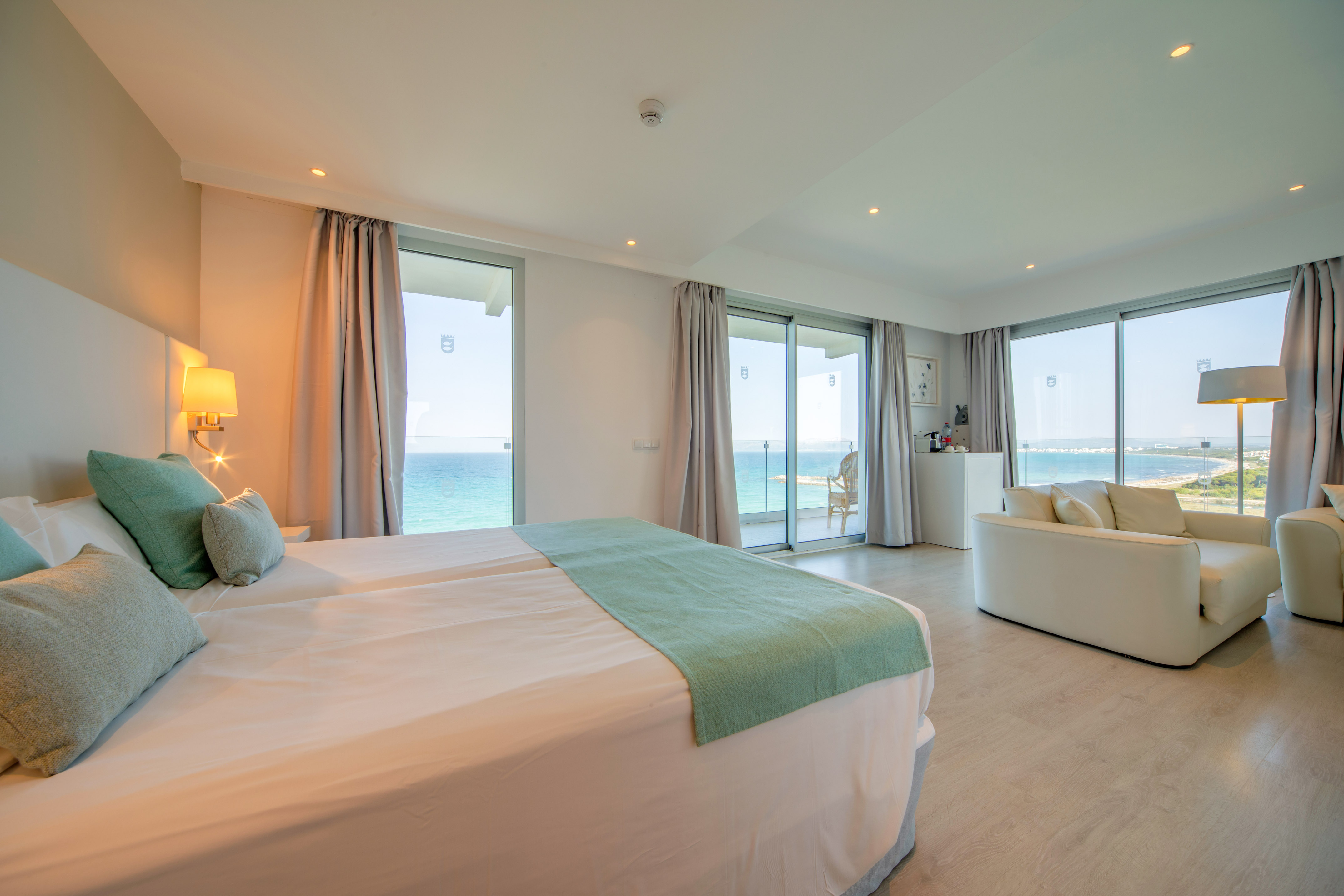 a bedroom with a large bed and a couch