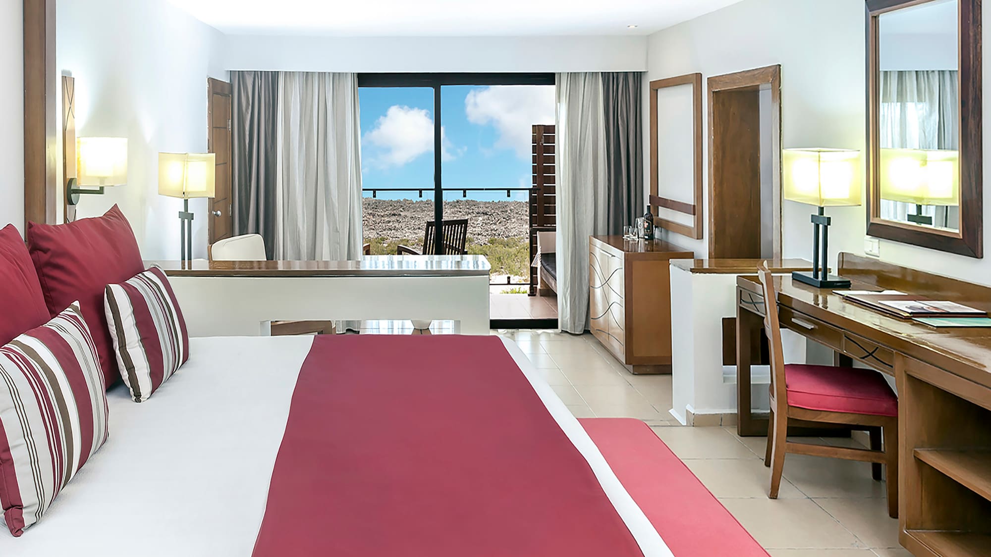a bedroom with a red bed and desk