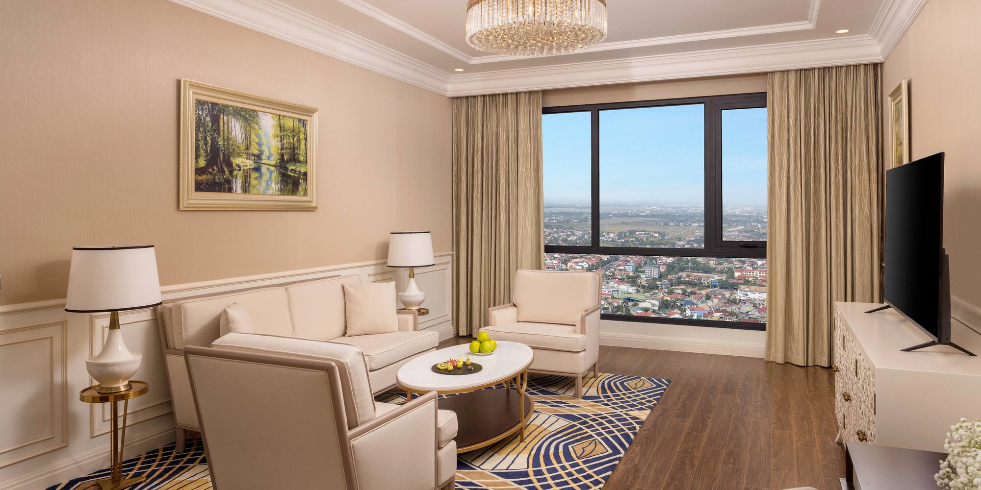 a living room with a large window and a couch and chairs