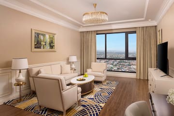 a living room with a large window and a couch and chairs