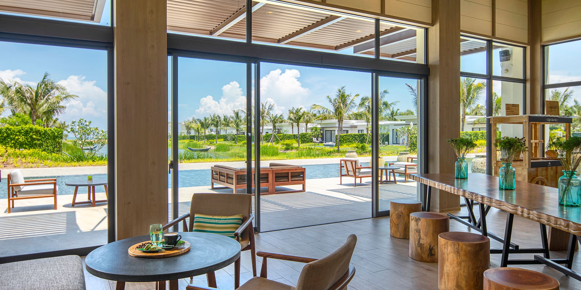 a room with a table and chairs and a pool