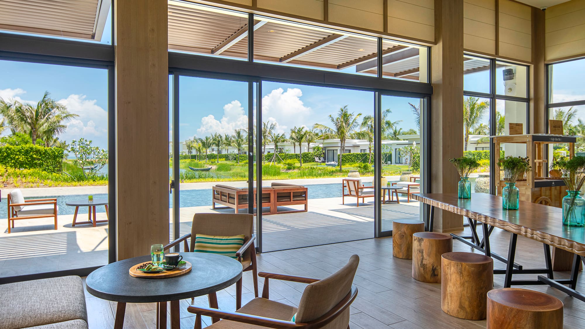 a room with a table and chairs and a pool