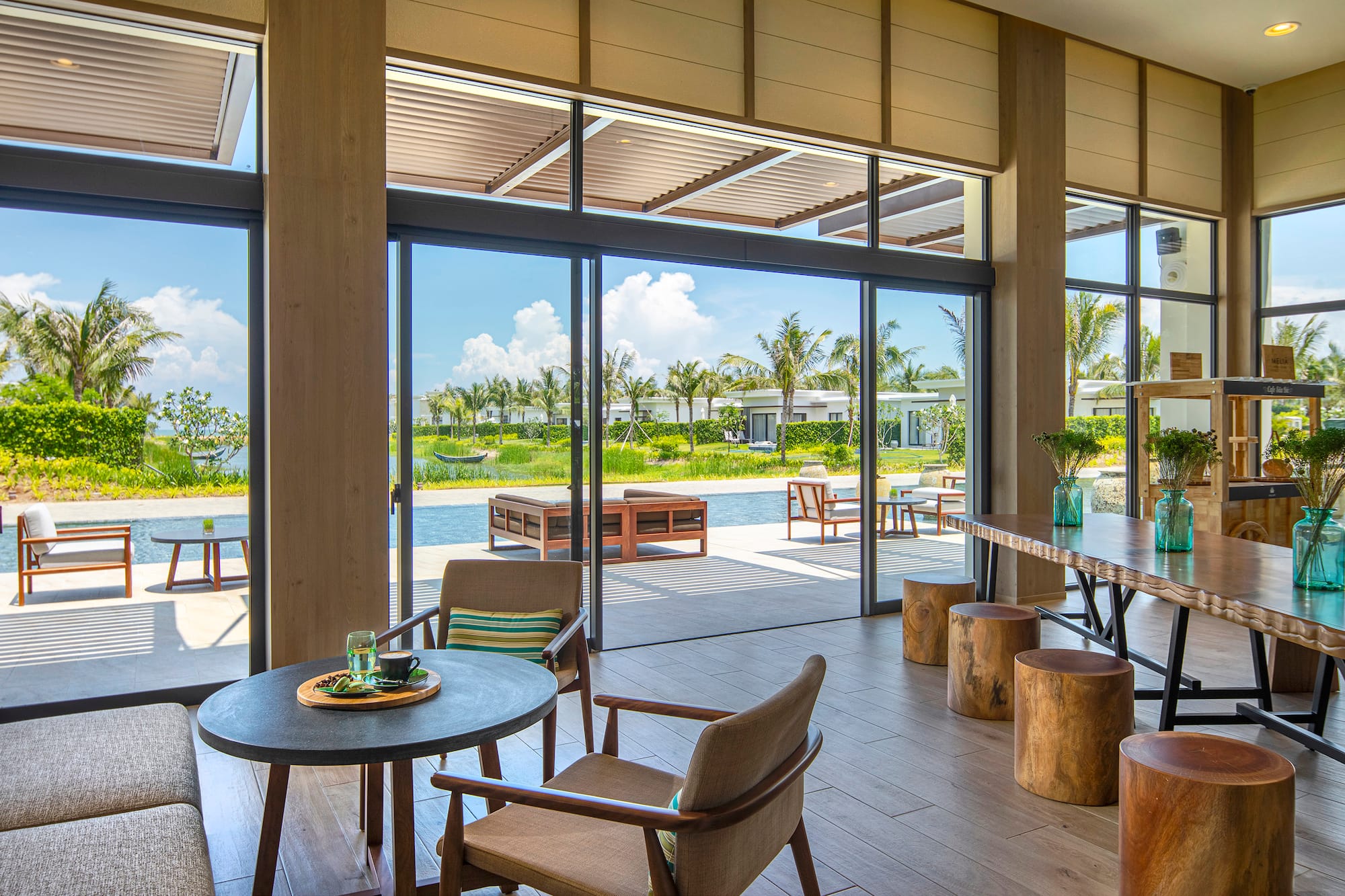 a room with a table and chairs and a pool