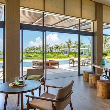 a room with a table and chairs and a pool