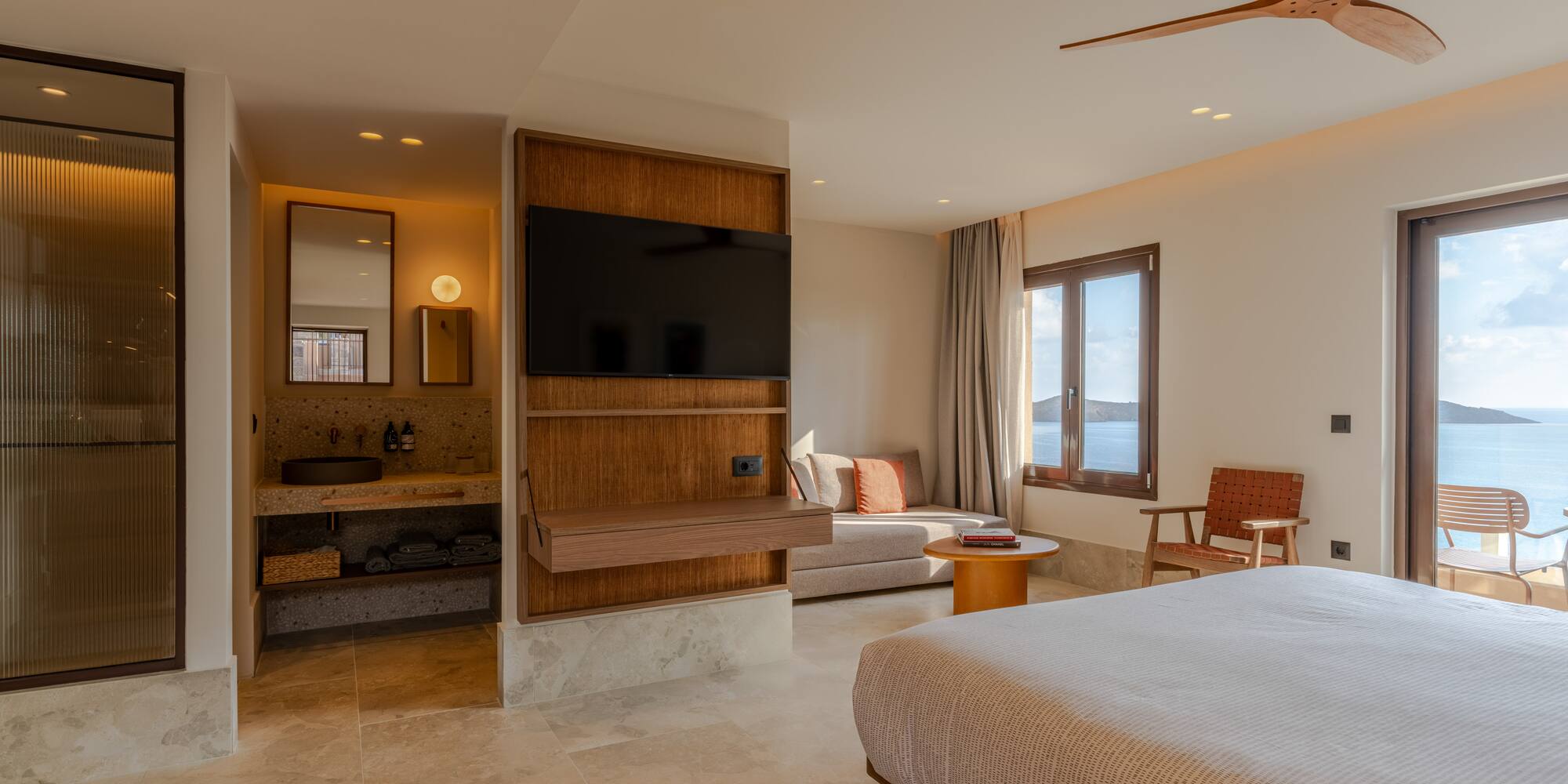 a room with a bed and a television