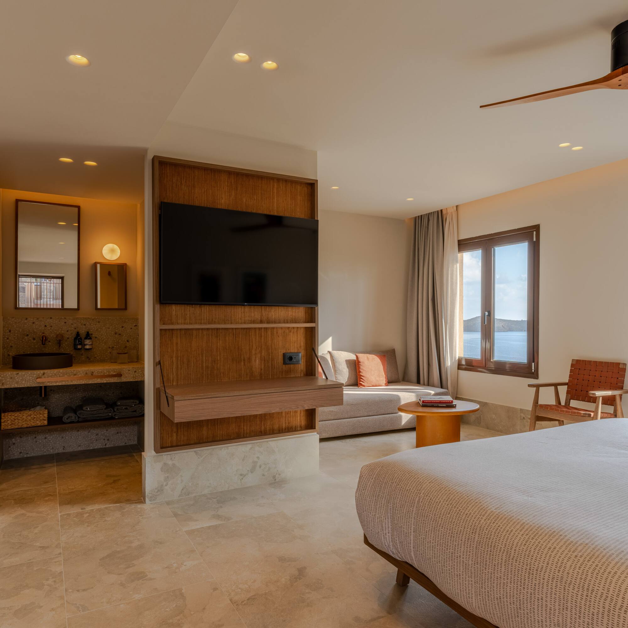 a room with a bed and a television